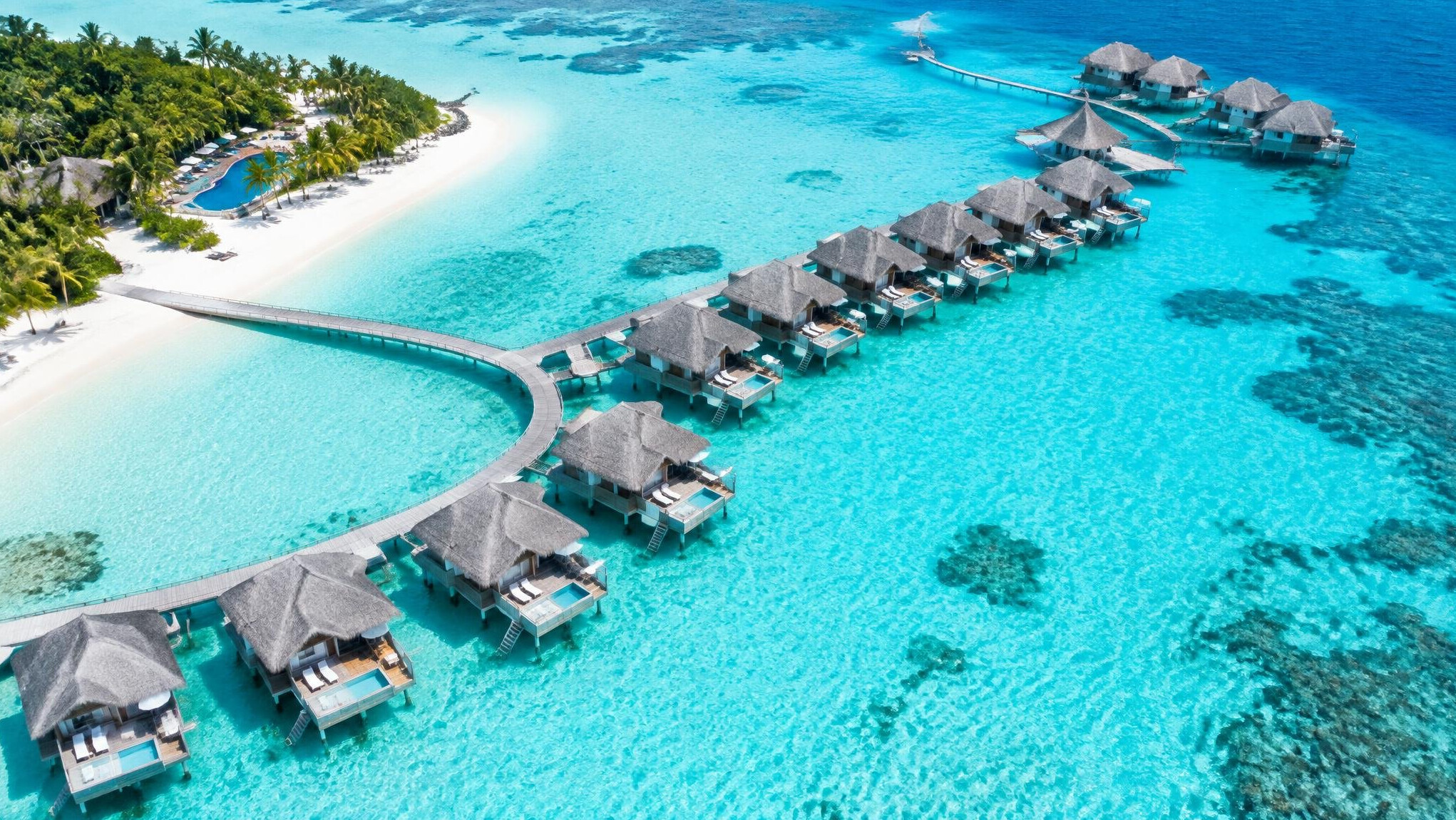 Overwater villas on turquoise lagoon in the Maldives